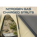 overland-vehicle-systems-ld-tmon-clamshell-aluminum-hard-shell-roof-top-tent-tan-close-up-view-with-nitrogen-gas-struts-in-nature