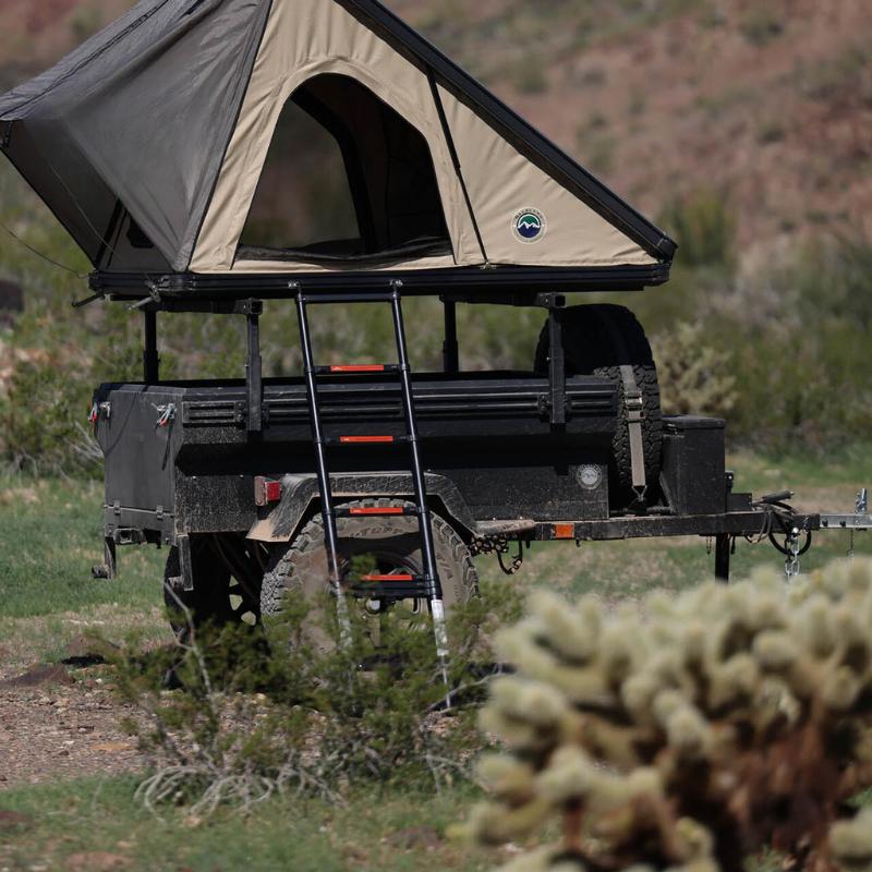 overland-vehicle-systems-off-road-trailer-side-view-with-open-roof-top-tent-in-nature