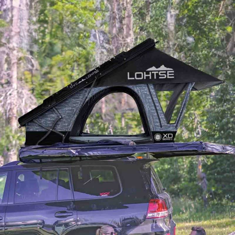 overland-vehicle-systems-xd-lohtse-hard-shell-roof-top-tent-gray-body-black-rainfly-open-side-view-on-vehicle-in-nature