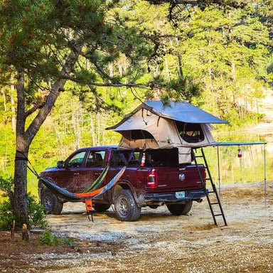 overland-vehicle-systems-tmbk-soft-shell-roof-top-tent-tan-open-side-corner-view-on-top-of-dodge_ram-in-nature