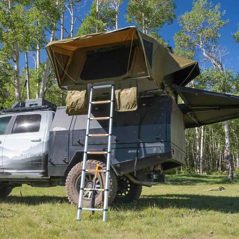 23zero-armadillo-a3-left-side-only-hard-shell-roof-top-tent-open-front-view-on-vehicle-with-ladder-in-nature