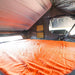 23zero-armadillo-x3-hard-shell-roof-top-tent-right-side-opening-open-interior-view-with-internal-pockets-on-white-background