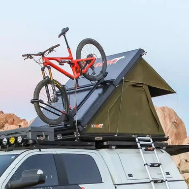 23zero-kabari-2-0-hard-shell-roof-top-tent-open-rear-corner-view-on-vehicle-with-bike-in-nature