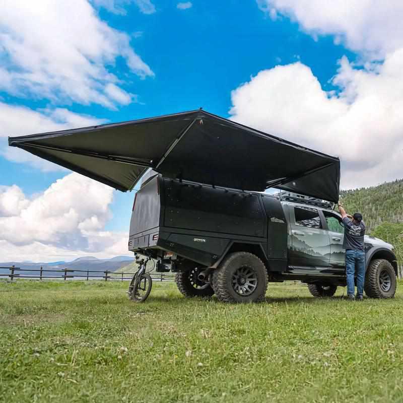 23zero-peregrine-pro-5-arm-270-awning-left-side-open-side-view-on-vehicle-with-person-in-nature