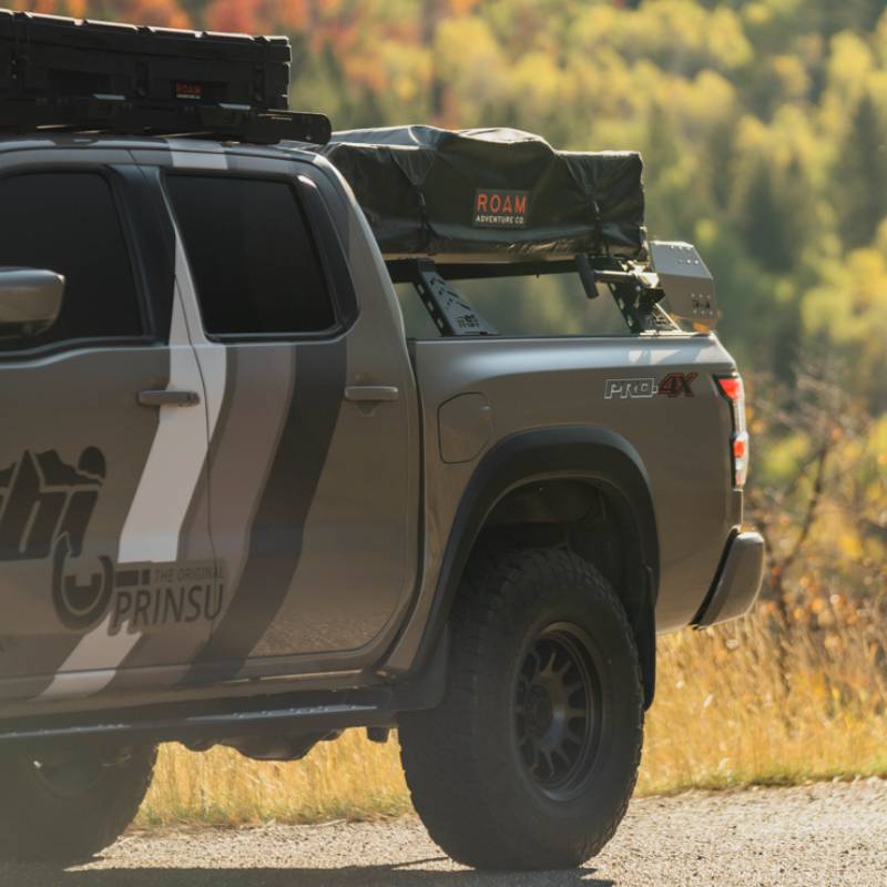 cbi-3rd-gen-nissan-frontier-bed-bars-2022-front-corner-view-with-roof-top-tent-on-vehicle-in-nature