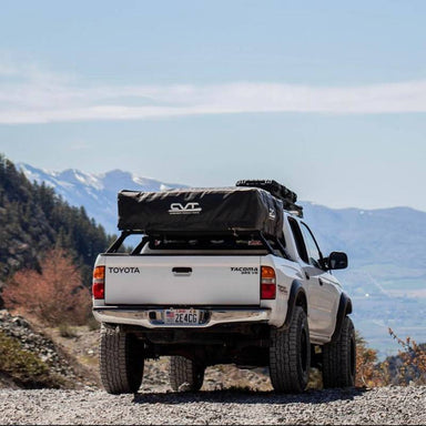 cbi-toyota-tacoma-cbi-overland-bed-bars-1996-2004-rear-view-with-roof-top-tent-in-nature