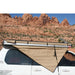 eezi-awn-bat-270-awning-beige-close-rear-side-view-unbuckled-in-nature
