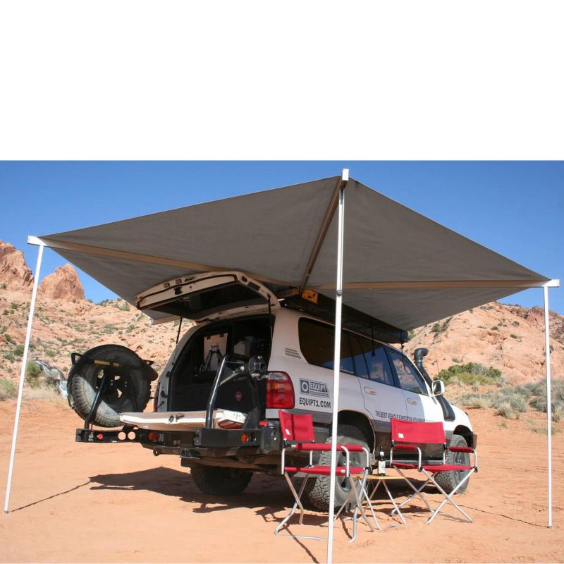 eezi-awn-bat-270-awning-beige-open-back-corner-view-ontop-of-land-cuiser-in-nature-with-folding-chairs