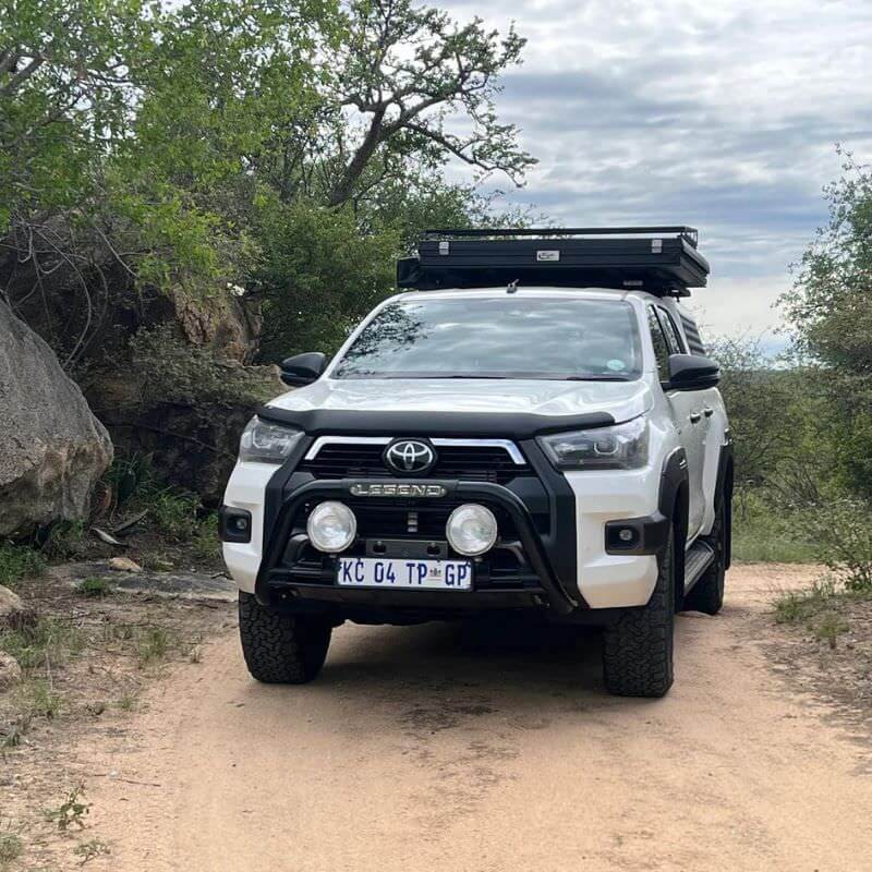 eezi-awn-blade-40th-edition-hard-shell-roof-top-tent-closed-front-view-on-a-pick-up-truck-in-nature