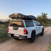 eezi-awn-blade-40th-edition-hard-shell-roof-top-tent-closed-rear-corner-view-on-vehicle-in-safari-area