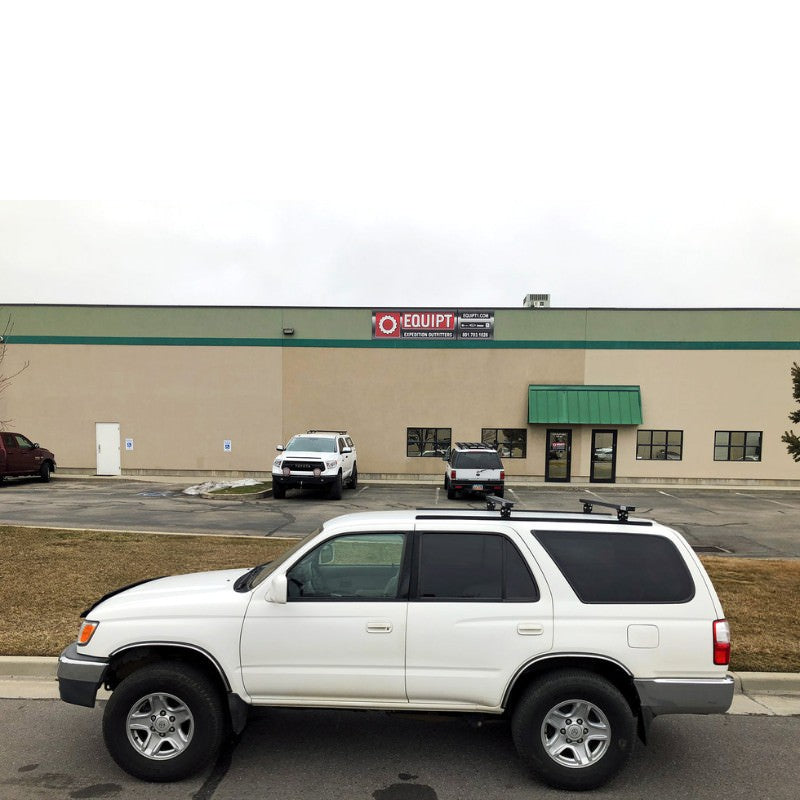 eezi-awn-k9-load-bar-kit-for-toyota-4runner-3rd-gen-side-view-with-buildings-and-vehicles-on-background-on-parking-area