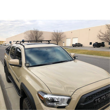 eezi-awn-k9-load-bar-kit-for-toyota-tacoma-3rd-gen-double-cab-front-corner-view-with-building-on-parking-area