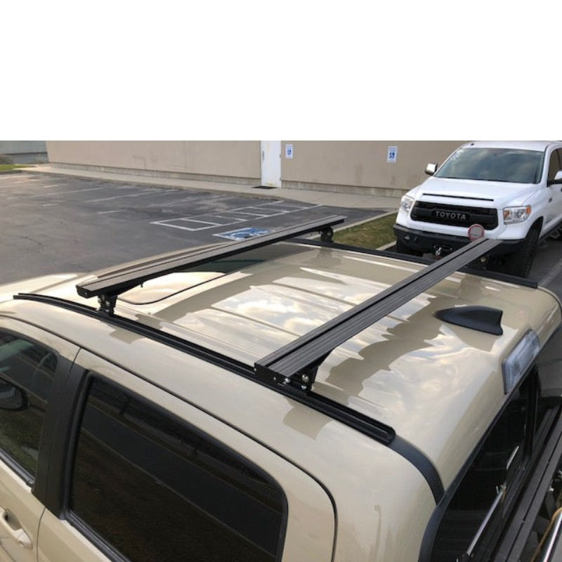 eezi-awn-k9-load-bar-kit-for-toyota-tacoma-3rd-gen-double-cab-rear-corner-view-with-vehicle-on-the-background