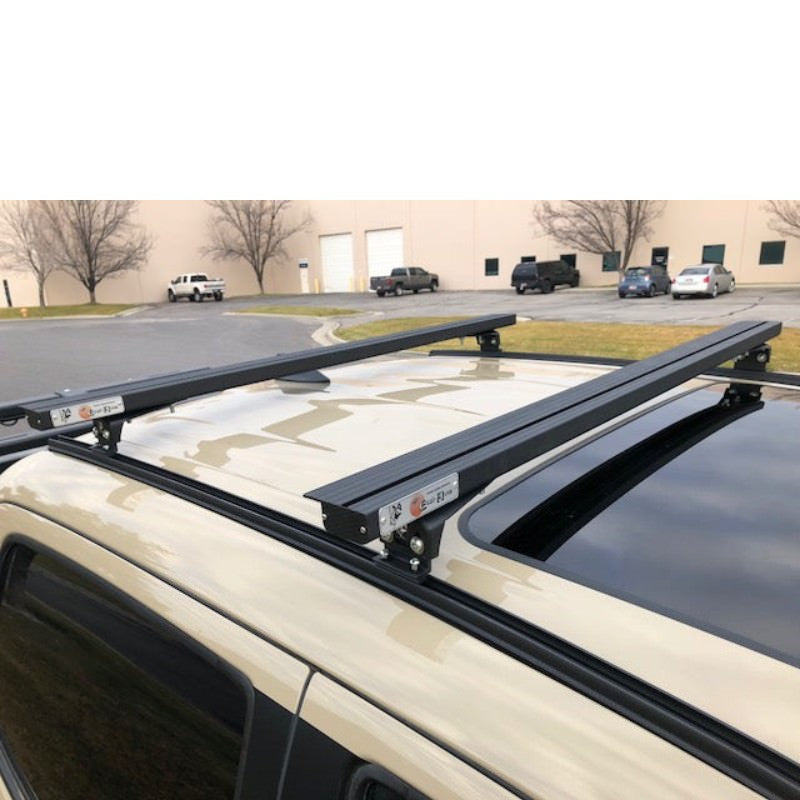 eezi-awn-k9-load-bar-kit-for-toyota-tacoma-3rd-gen-double-cab-top-view-with-building-on-parking-area