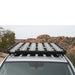 eezi-awn-k9-roof-rack-for-toyota-4runner-5th-gen-on-white-background-front-view-with-logo-sticker-in-terrain