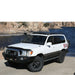 eezi-awn-k9-roof-rack-for-toyota-land-cruiser-100-series-front-corner-view-with-lake-in-nature