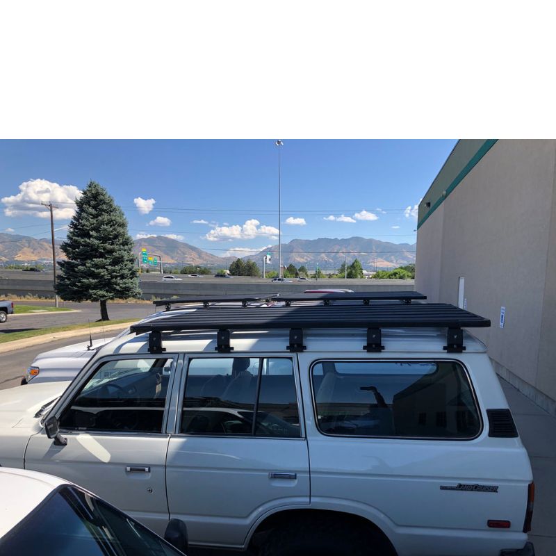 eezi-awn-k9-roof-rack-for-toyota-land-cruiser-60-side-view-with-vehicles-in-parking-lot