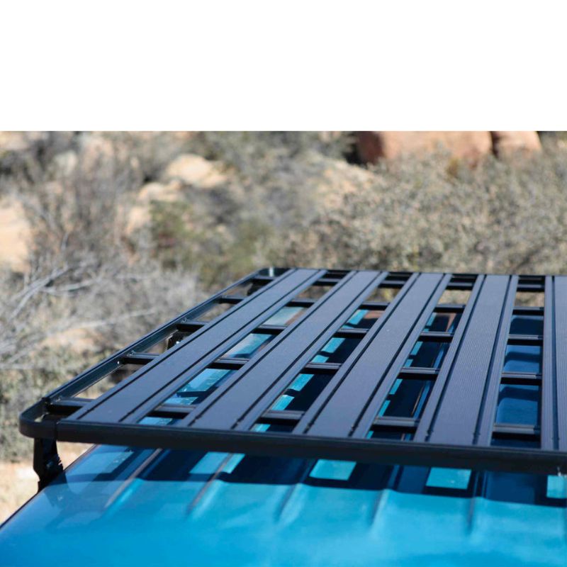 eezi-awn-k9-roof-rack-for-toyota-land-cruiser-60-top-view-with-shrubs-on-background-on-blue-land-cruiser-in-nature