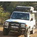 eezi-awn-k9-roof-rack-for-toyota-land-cruiser-70-series-front-view-with-roof-top-tent-in-nature