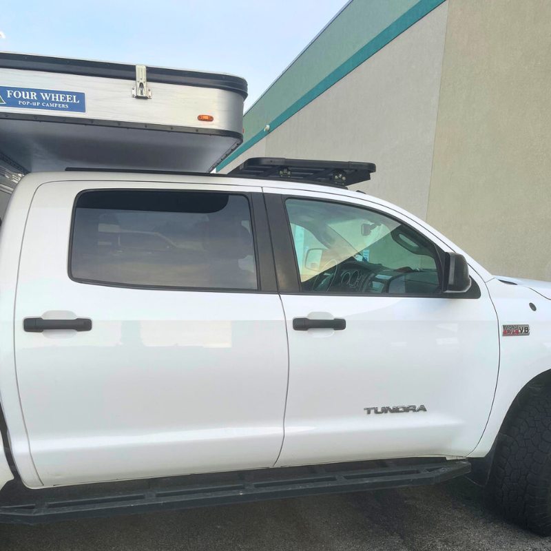 eezi-awn-k9-roof-rack-for-toyota-tundra-2nd-gen-side-view-with-pop-up-camper-in-parking-area