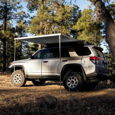 eezi-awn-lite-awning-gray-open-side-view-on-toyota-4runner-in-terrain