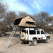 eezi-awn-series-3-roof-top-tent-beige-open-backend-rear-corner-view-on-land-rover-defender-at-campsite