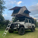 eezi-awn-series-3-roof-top-tent-beige-open-forward-front-corner-view-on-land-rover-defender-on-lawn