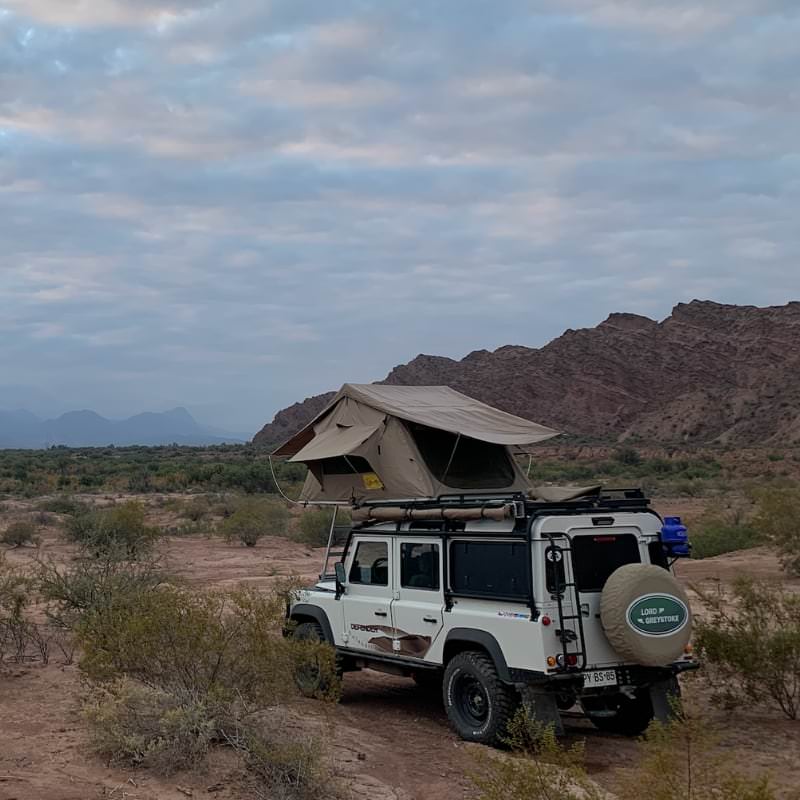 eezi-awn-series-3-roof-top-tent-beige-open-rear-corner-view-on-land-rover-defender-in-desert