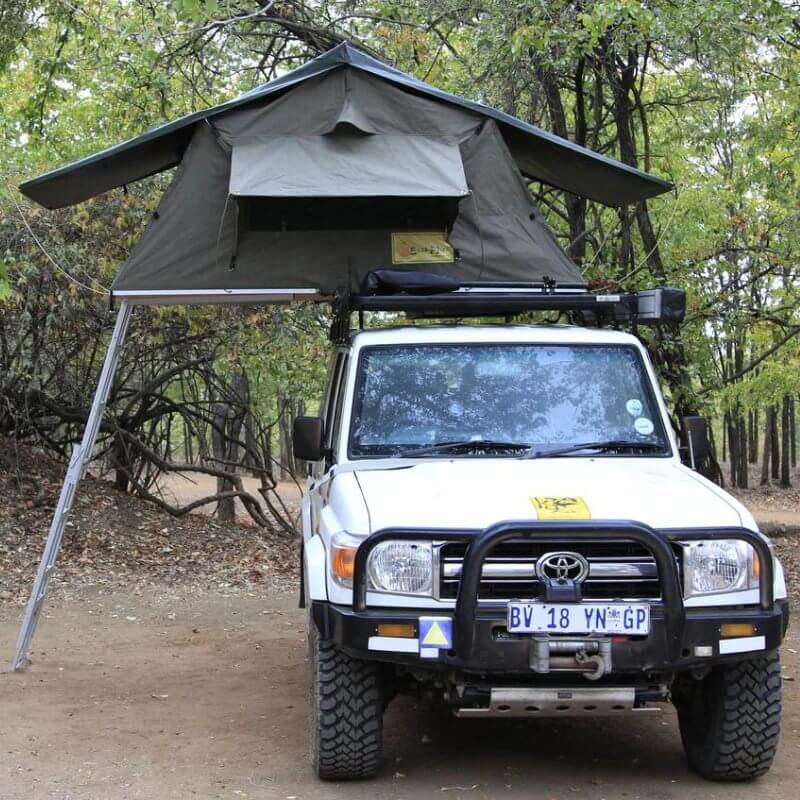 eezi-awn-series-3-soft-shell-roof-top-tent-open-front-view-on-vehicle-with-extended-ladder-in-nature