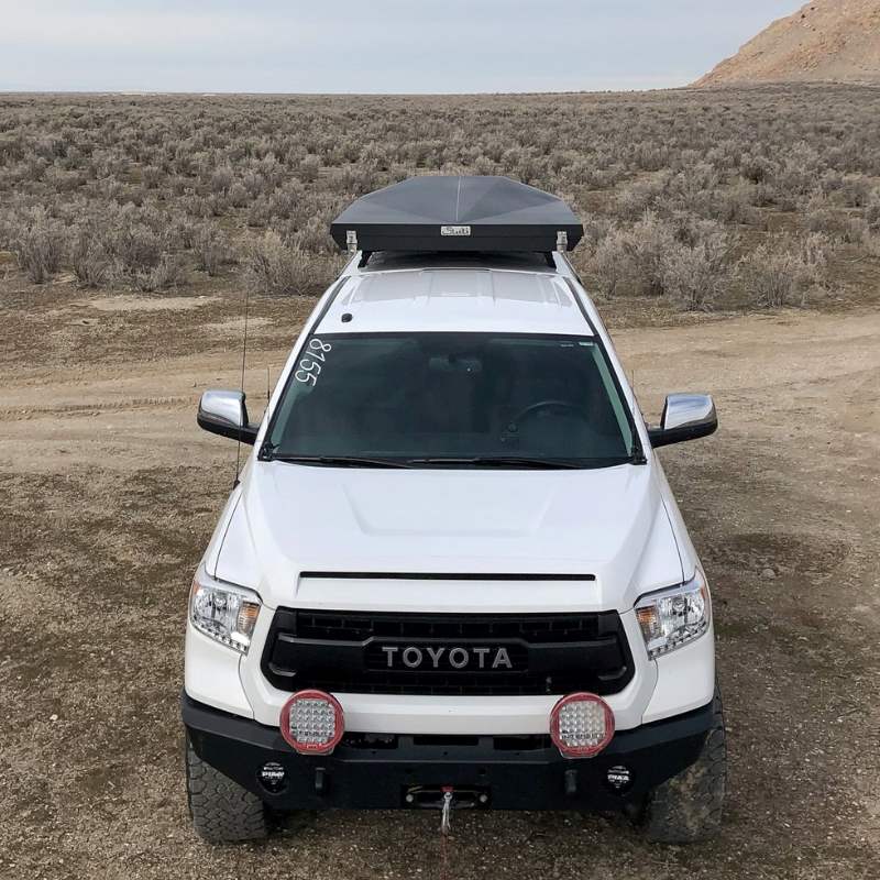 eezi-awn-stealth-hard-shell-roof-top-tent-closed-front-view-on-toyota-tundra-in-desert