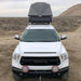 eezi-awn-stealth-hard-shell-roof-top-tent-open-front-view-on-toyota-tundra-in-desert