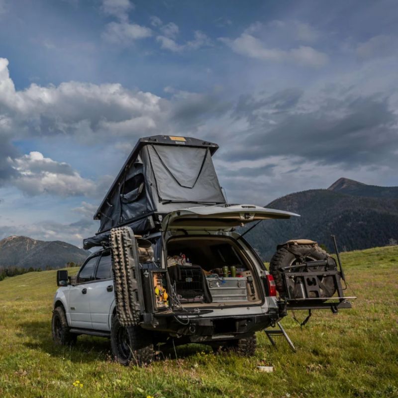 eezi-awn-stealth-hard-shell-roof-top-tent-open-rear-view-on-ford-explorer-in-the-mountains