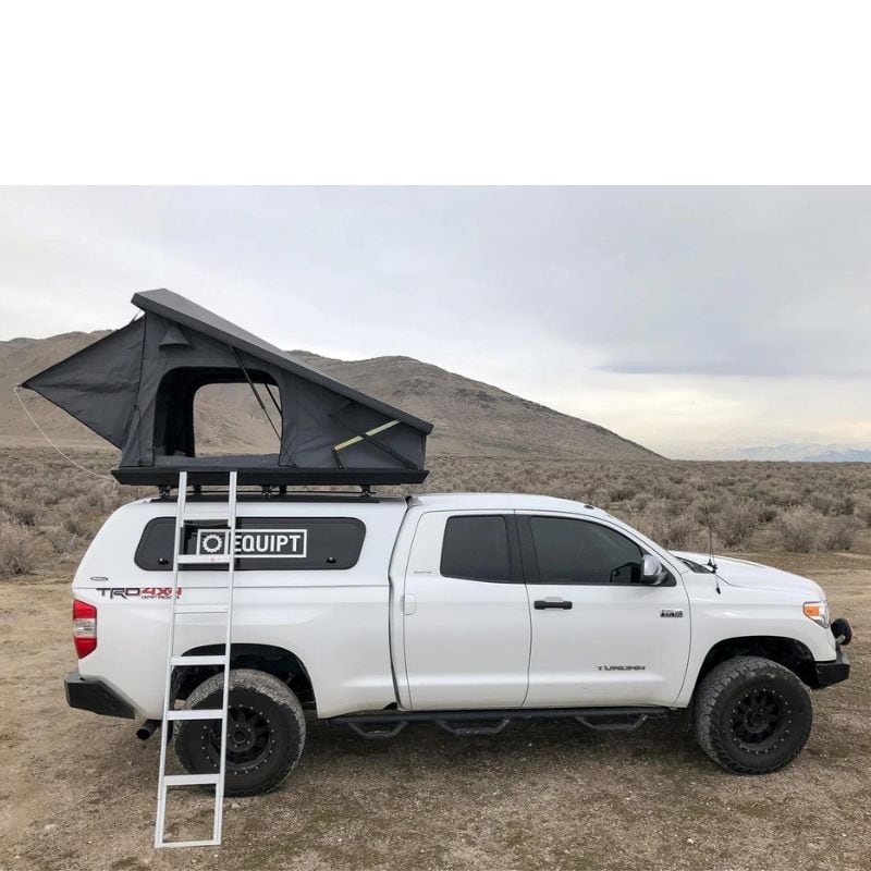 eezi-awn-stealth-hard-shell-roof-top-tent-open-side-view-with-pitched-rainfly-on-toyota-tundra-in-desert