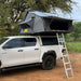 eezi-awn-sword-hard-shell-roof-top-tent-open-side-view-on-vehicle-with-extended-ladder-in-nature