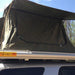 eezi-awn-xklusiv-soft-shell-roof-top-tent-olive-open-closed-up-view-on-vehicle-with-protective-overhang