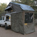 eezi-awn-xklusiv-soft-shell-roof-top-tent-olive-open-rear-corner-view-on-vehicle-with-extended-room-in-nature