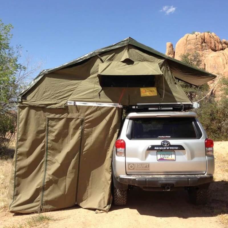 eezi-awn-xklusiv-soft-shell-roof-top-tent-olive-open-rear-view-on-vehicle-in-desert