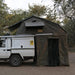 eezi-awn-xklusiv-soft-shell-roof-top-tent-olive-open-side-view-on-vehicle-with-extended-room-in-nature