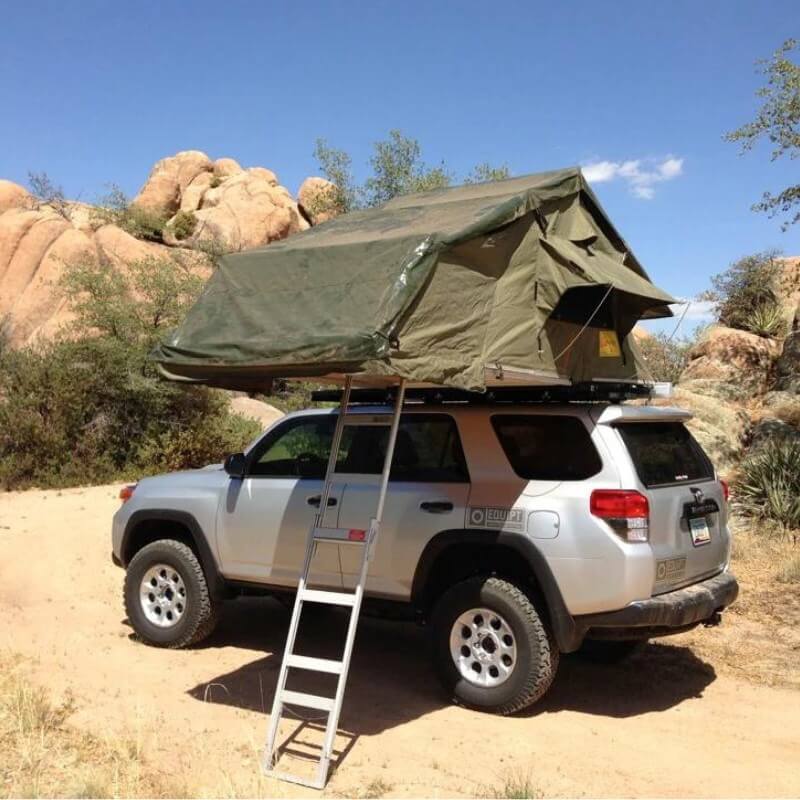eezi-awn-xklusiv-soft-shell-roof-top-tent-olive-open-side-view-on-vehicle-with-ladder-in-desert