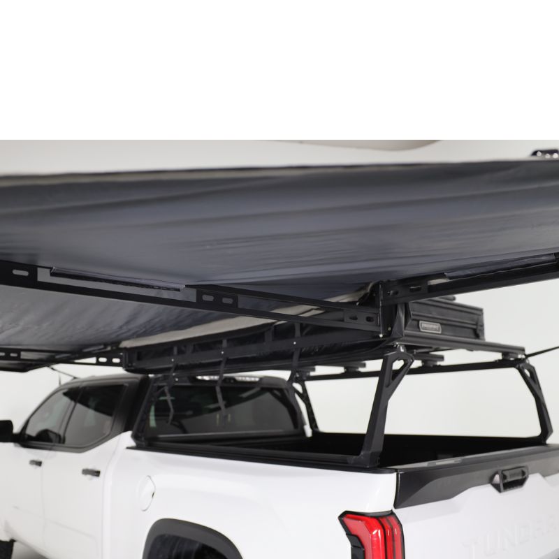 freespirit-recreation-180-degree-awning-black-open-close-up-view-with-pvc-inner-coating-on-toyota-tundra-on-white-background