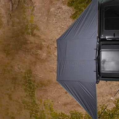 freespirit-recreation-180-degree-awning-black-open-top-view-on-vehicle-in-nature