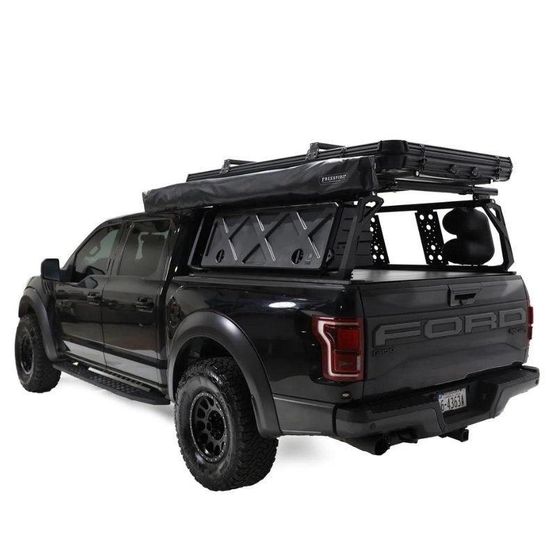 freespirit-recreation-270-awning-driver-side-closed-rear-corner-view-on-ford-f150-with-roof-rack-system-on-white-background