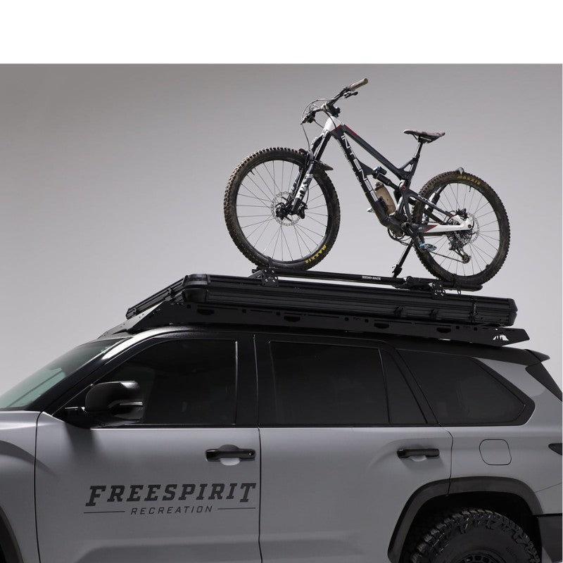 freespirit-recreation-aspen-v2-xl-hard-shell-roof-top-tent-black-closed-side-view-on-top-toyota-sequoia-with-bike-on-white-background