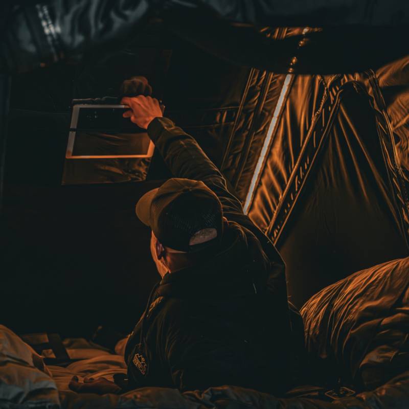 freespirit-recreation-aspen-v2-xl-hard-shell-roof-top-tent-black-open-interior-view-with-man-and-led-light-strip
