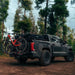 freespirit-recreation-high-country-v2-king-hybrid-roof-top-tent-closed-rear-corner-view-on-truck-with-mountain-bikes-in-forest