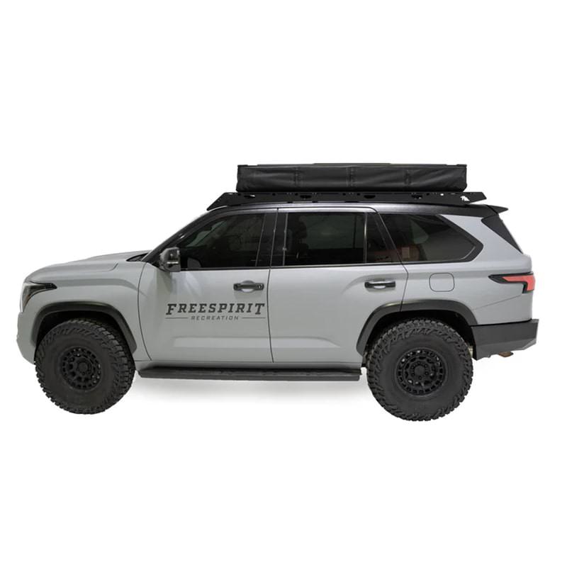 freespirit-recreation-high-country-v2-king-hybrid-roof-top-tent-closed-side-view-on-vehicle-with-roof-rack-system-on-white-backgound