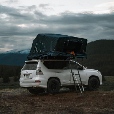 freespirit-recreation-high-country-v2-king-hybrid-roof-top-tent-open-rear-corner-view-on-vehicle-in-nature