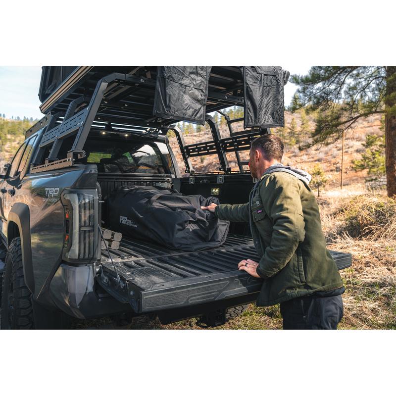 freespirit-recreation-hub-4-double-tent-black-packed-and-stored-in-bed-of-truck-in-nature