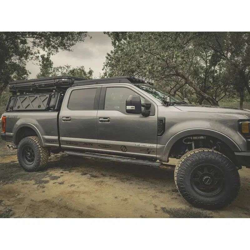 leitner-acs-roof-over-cab-platform-rack-for-ford-f250-side-view-with-roof-top-tent-in-nature