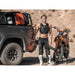 leitner-hydropod-acs-rack-shower-kit-water-tank-front-corner-view-on-vehicle-with-person-and-motorcycle-in-terrain